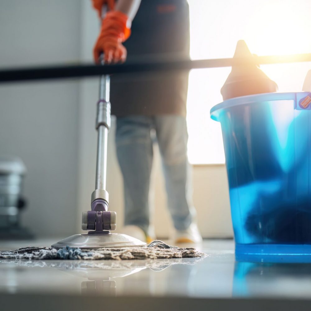 a-cleaning-woman-is-standing-inside-a-building-hol-2026-03-17-06-52-03-utc