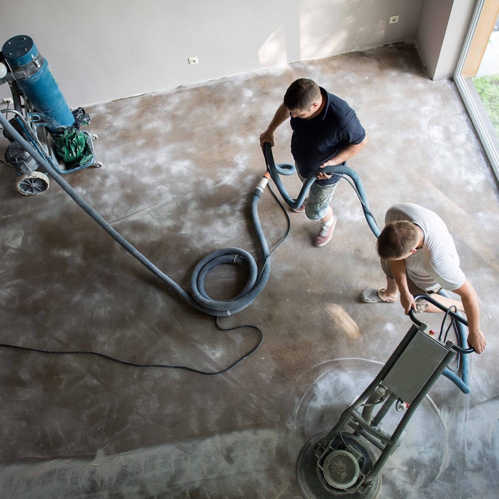 men-smoothing-concrete-floor-in-room-with-tools-2026-03-20-01-59-13-utc